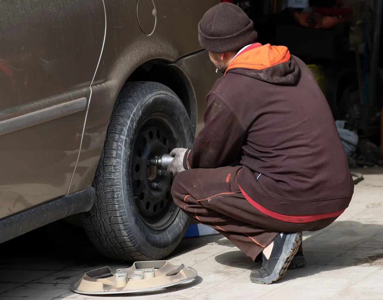 Technician working on a vehicle wheel in the shop